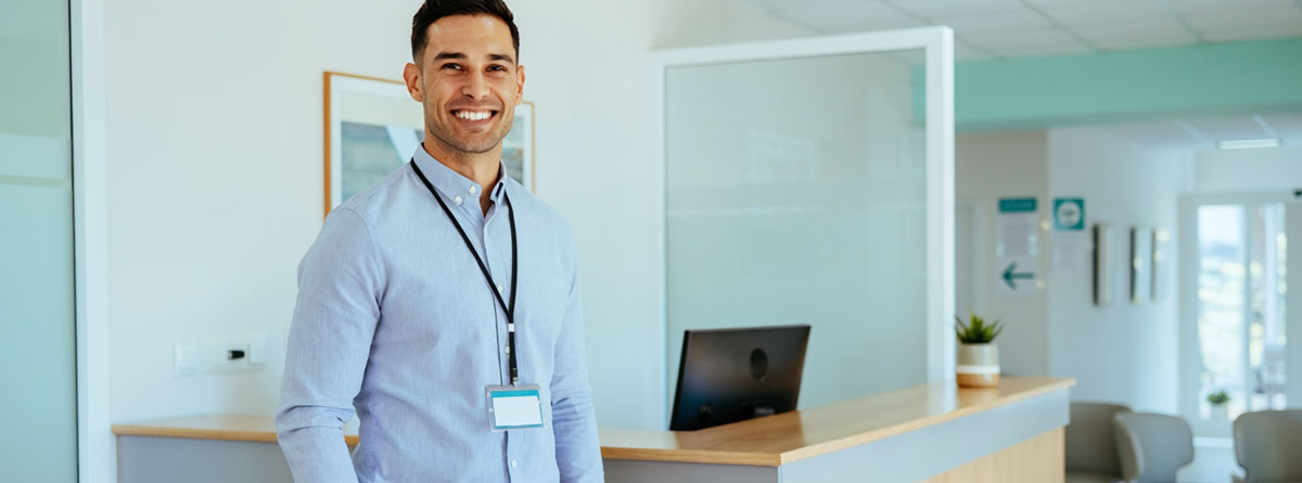 Man standing in the lobby of a clinic.